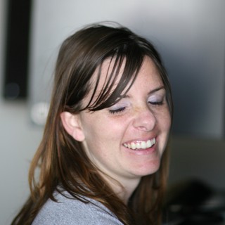 Candid Laughter: Woman Smiling with Eyes Closed