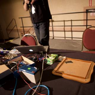 Hard at Work Caption: A man diligently types away on his laptop at the Defcon 17 conference, surrounded by multiple screens and electronics.