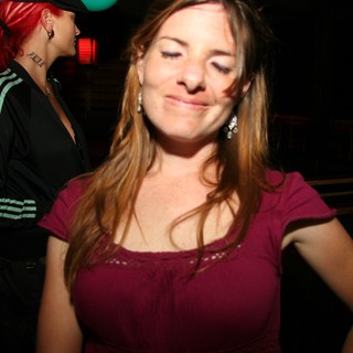 Woman Smiling at Nightclub Party in 2005