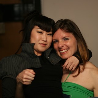 Two Friends Share a Warm Embrace at Party