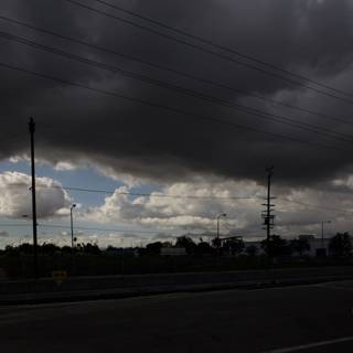 A Dark Sky over Power Lines and Street