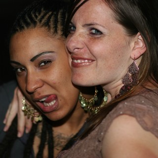 Two Friends Sharing a Joyful Moment at Nightclub