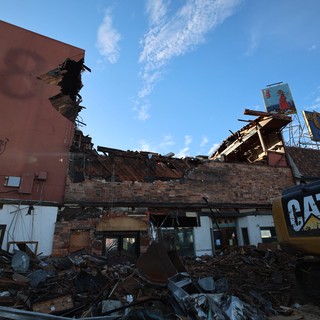 Urban Demolition Site with CAT Excavator at Dusk