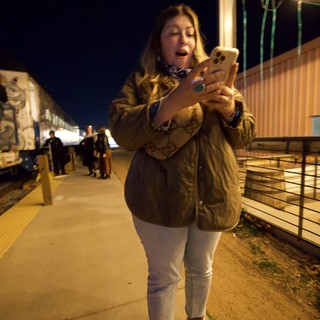 Late Night Phone Check at Train Platform