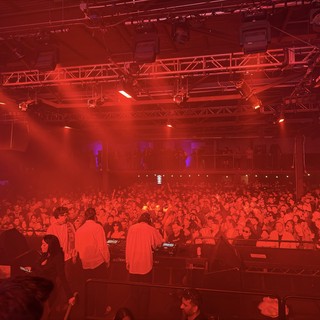 Red Light Concert Energy: DJ Performance at Packed Venue