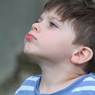 Young Boy Looking Upward in Contemplative Profile Portrait