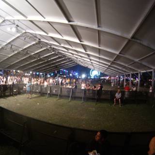 Nighttime Crowd under Tent Canopy