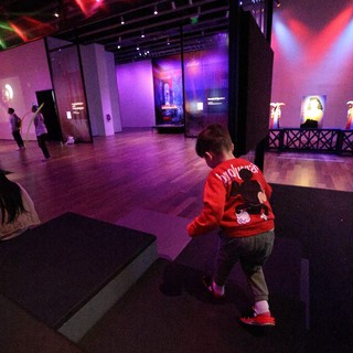 Child Exploring Modern Art Exhibition Space