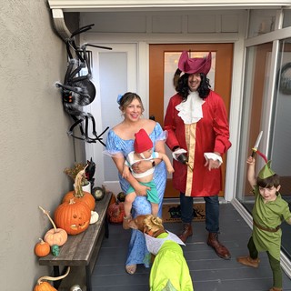 Family Peter Pan Halloween Costume Portrait on Decorated Porch