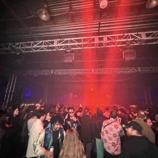 Red-Lit Crowd at Electronic Music Nightclub Event