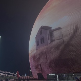 Futuristic Sphere Building with Digital Display at Night
