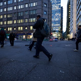 Urban Commuter Crossing City Square at Dusk