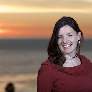 Smiling Woman at Golden Hour Seaside Sunset