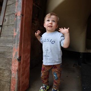 Young Child's Wonder in Rustic Doorway