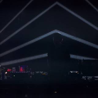 DJ plays music in front of giant screen at 2010 concert