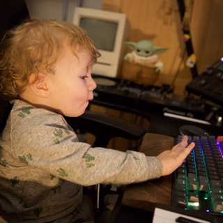 Young Child Exploring Music Production Equipment at Home
