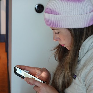 Young Woman Using Smartphone in Winter Coat