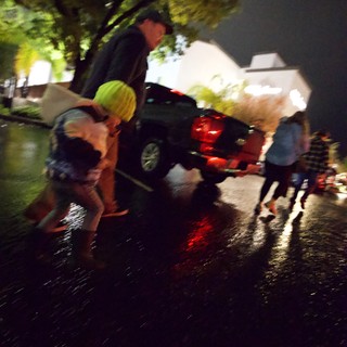 Nighttime Emergency Scene with Wet Streets and Responders