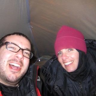 Two Friends Laughing Together Inside a Camping Tent