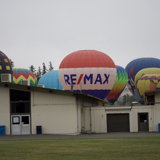 RE/MAX Hot Air Balloons Rise Over Fairgrounds Buildings