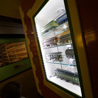 Child Observing Vintage Model Train Display in Museum