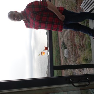 Man Enjoying Coastal Drinks at Scenic Overlook