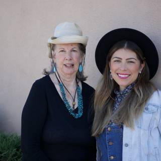 Two Women Rocking Hats and Smiling