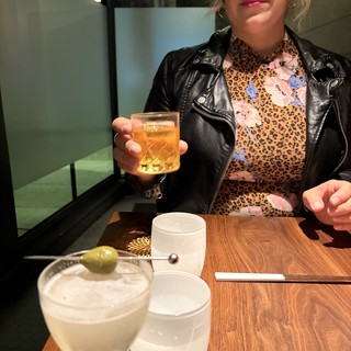 Woman Enjoying Cocktails at Modern Restaurant Table