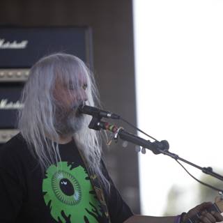 Musical Performance by a White Haired Guitarist