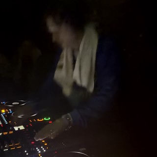 DJ Performance in Dimly Lit London Nightclub