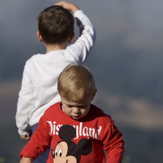 Two Young Boys Exploring Under Stormy Skies