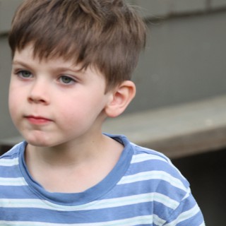 Thoughtful Young Boy in Striped Shirt