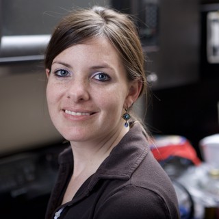 Smiling Woman with Blue Eyes in Office Setting
