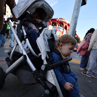 Young Child in Stroller at Evening Street Event