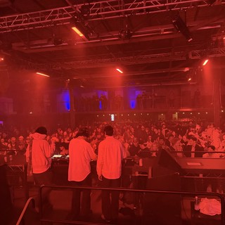 Electronic Music Event Under Dramatic Red Stage Lighting