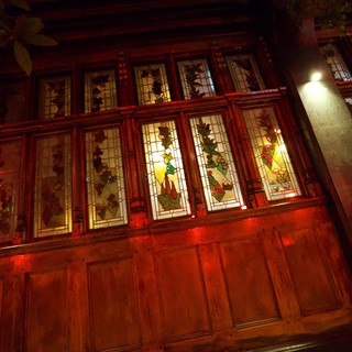 Traditional Chinese Building with Illuminated Stained Glass Windows at Night