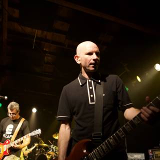 Bald-Headed Guitarist Rocks the Stage