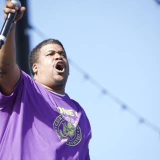 Purple Shirted Singer Serenades the Sunday Stage