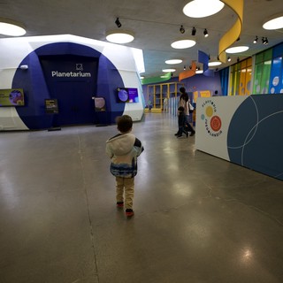Child Explores Modern Interactive Science Museum Planetarium