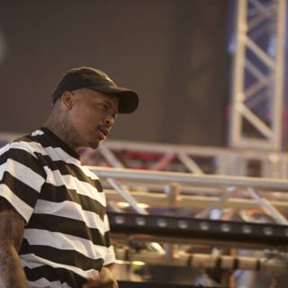 YG Takes the Stage in Stripes and Cap