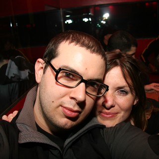 Couple Poses Together at Dimly Lit Nightclub