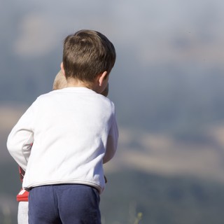 Young Child Gazing Out Over Mountain Vistas