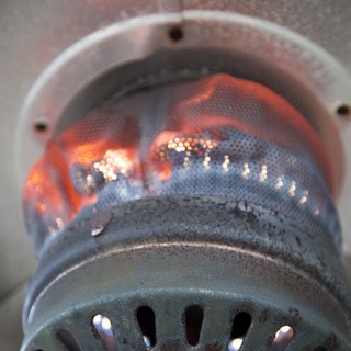 Glowing Flames Inside a Metal Burner Chamber