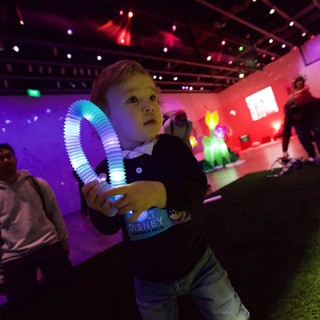 Child with Glowing Toy at Baby Rave Event