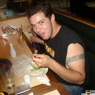 Tattooed Man Enjoying His Meal