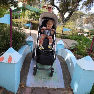 Parent and Child Navigate Whimsical Garden Bridge