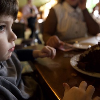 Young Child's Wonder at Dinner Table