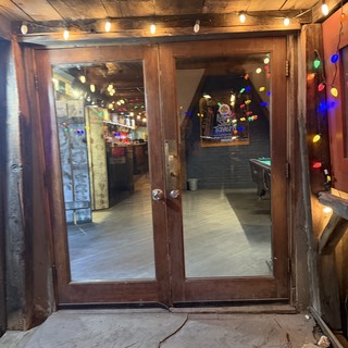 Rustic Tavern Entrance Decorated with Festive String Lights