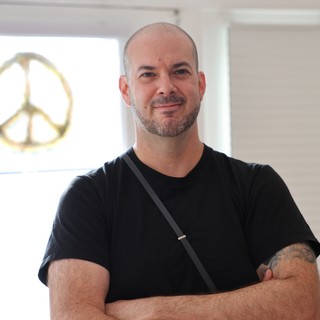 Portrait of Man in Black Shirt with Peace Sign