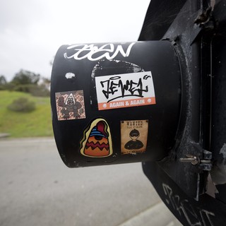 Travel Stickers on Black Cylindrical Post